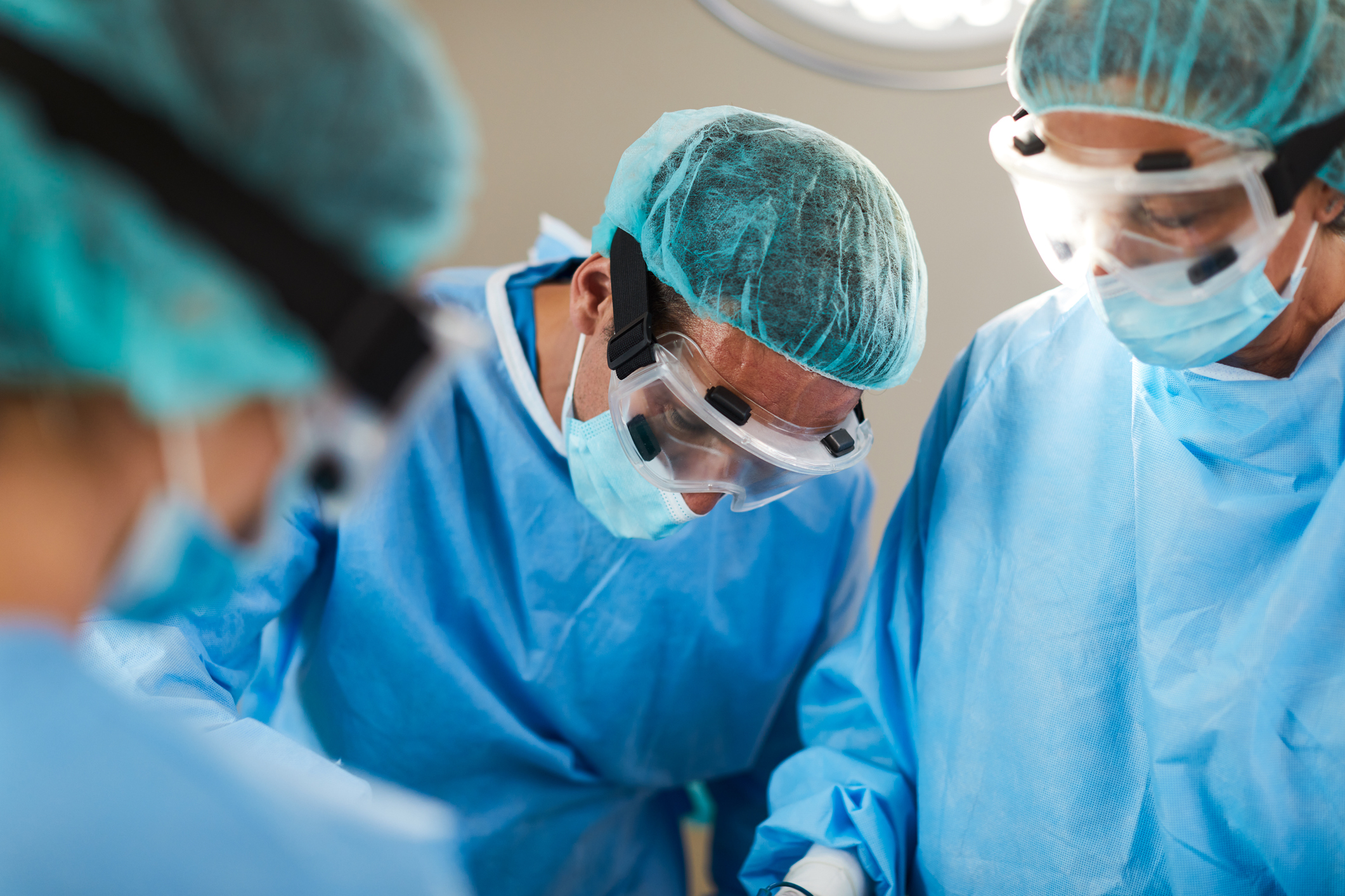 Surgeon bending over to get a closer look during operation