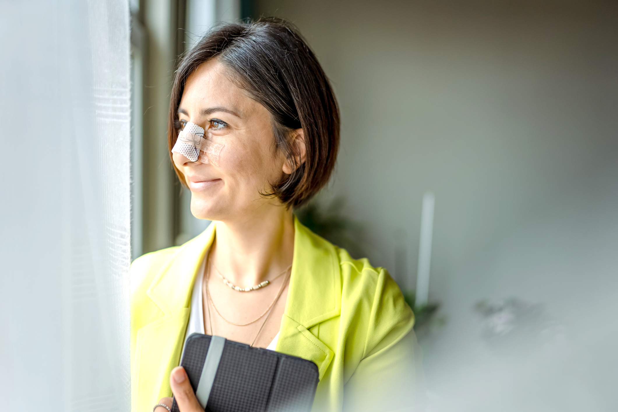 Business woman having online meeting after nose surgery